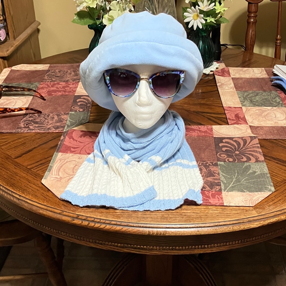 Sky, blue hat, scarf, and sunglasses